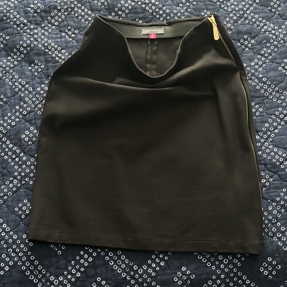 Form fitting black skirt with amazing gold zipper detail down length of skirt.